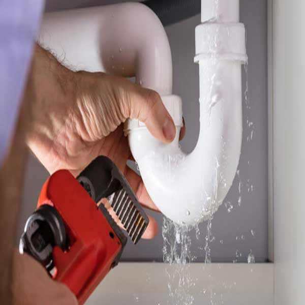 image of a Plumber fixing a leak