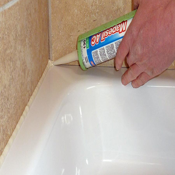 image of someone applying Silicone to a Bath in a Bathroom